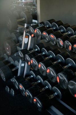 A neatly arranged set of dumbbells in a fitness center gym, ideal for strength training.